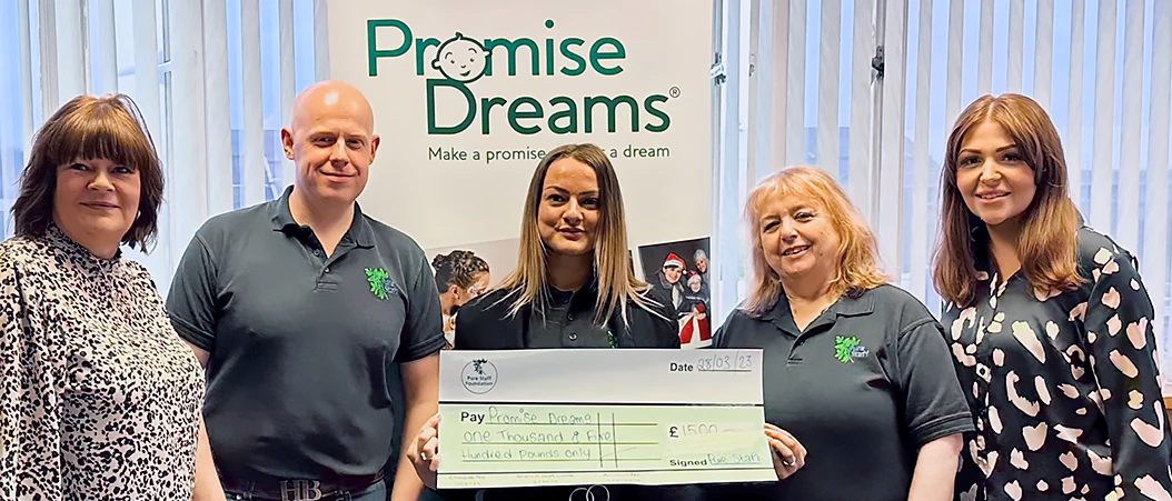 A banner image of the Pure Staff Foundation team holding a cheque of £1,500 for the Promise Dreams charity.