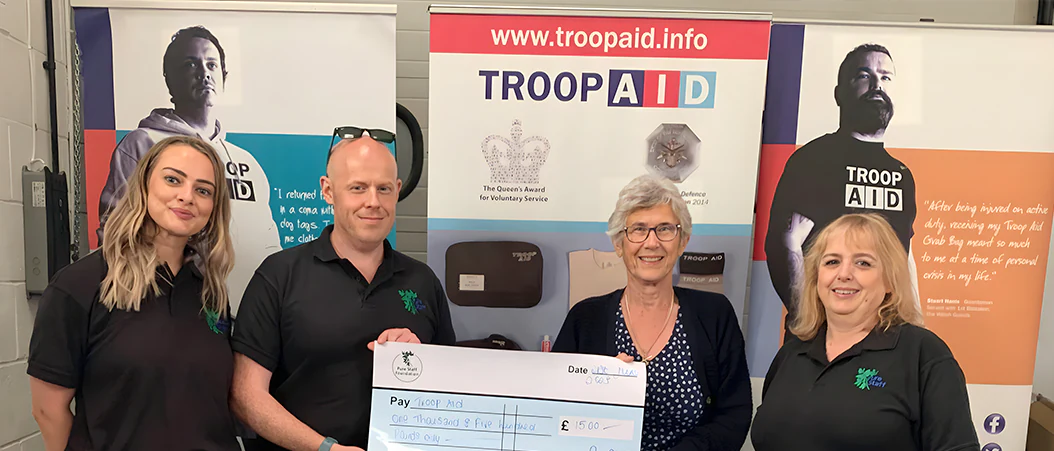 Image of Pure Staff Foundation team donating £1,500 to Troop Aid.